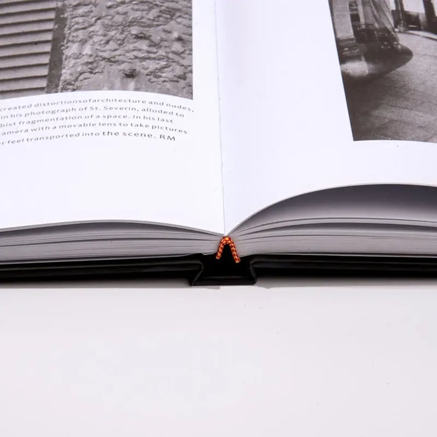 Open coffee table book with visible spine and B&W photos