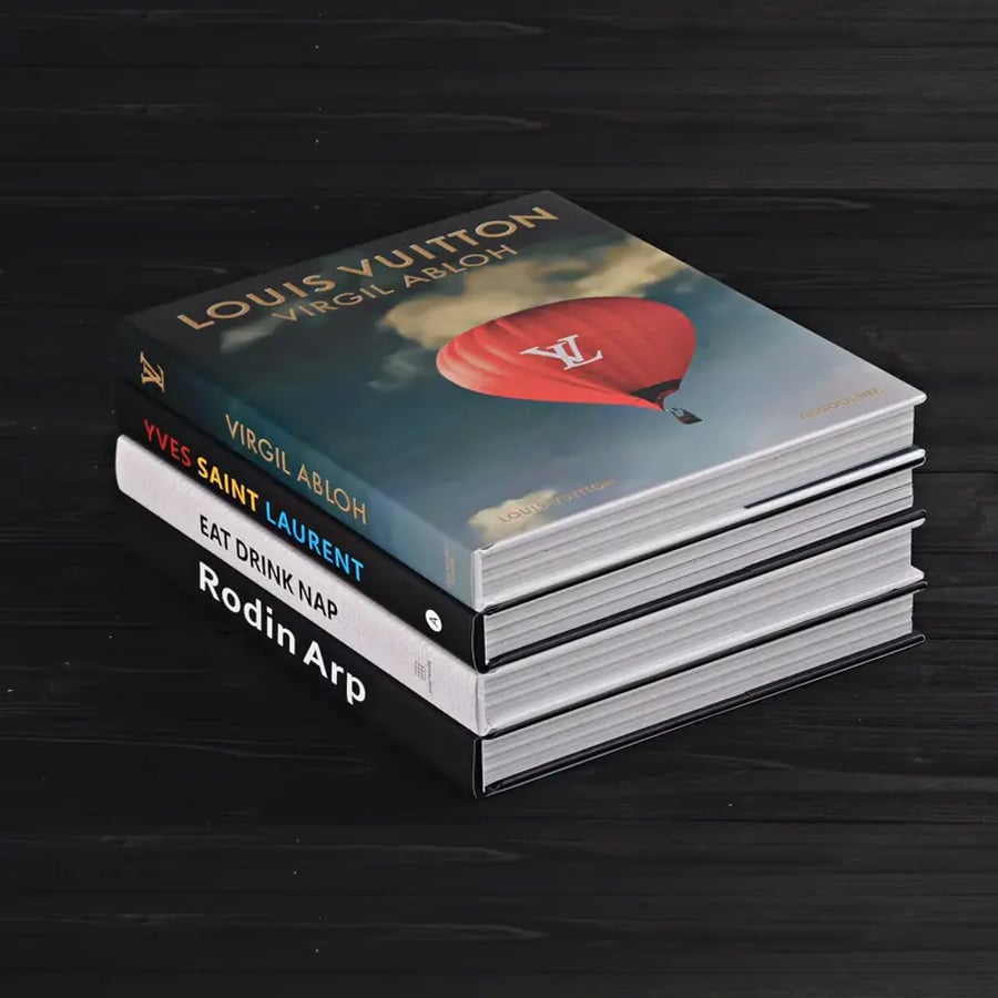 Stack of dark themed hardcover coffee table books